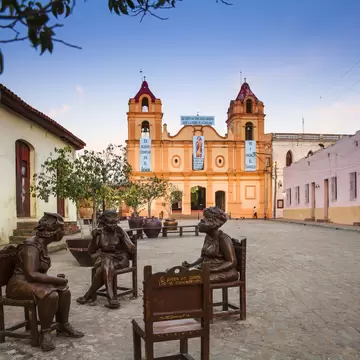 Cuba, Camaguey, Camaguey Province, Plaza Del Carmen, Iglesia de Nuestra Senora del Carmen and Unique life-sized sculptures of camagueyanos going about their daily life