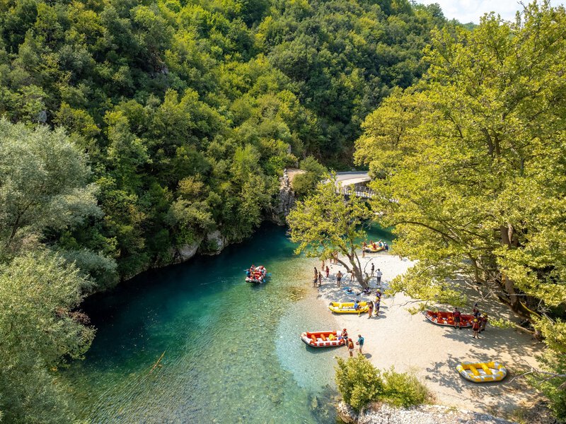 aerial view of rafting boats and athletes in river Voidomatis with the famous clear waters in epirus Greece.
