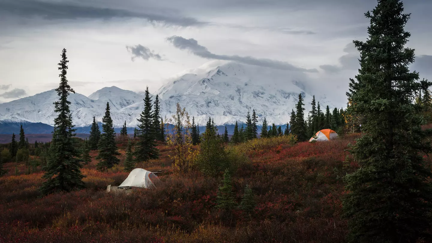 Two tents at the Wonder Lake campground, with the snow-capped Mount Denali in the background. ©JIA HE/Alamy Stock Photo