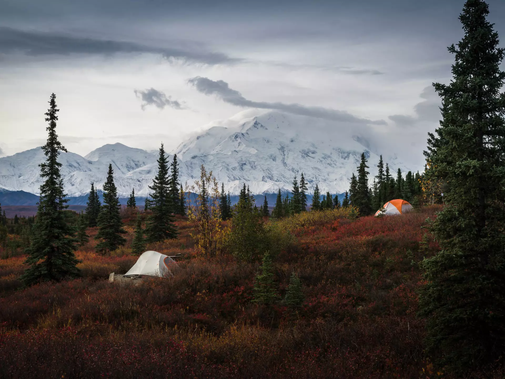 Two tents at the Wonder Lake campground, with the snow-capped Mount Denali in the background. ©JIA HE/Alamy Stock Photo