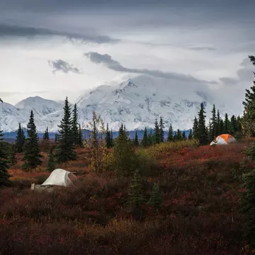 Two tents at the Wonder Lake campground, with the snow-capped Mount Denali in the background. ©JIA HE/Alamy Stock Photo