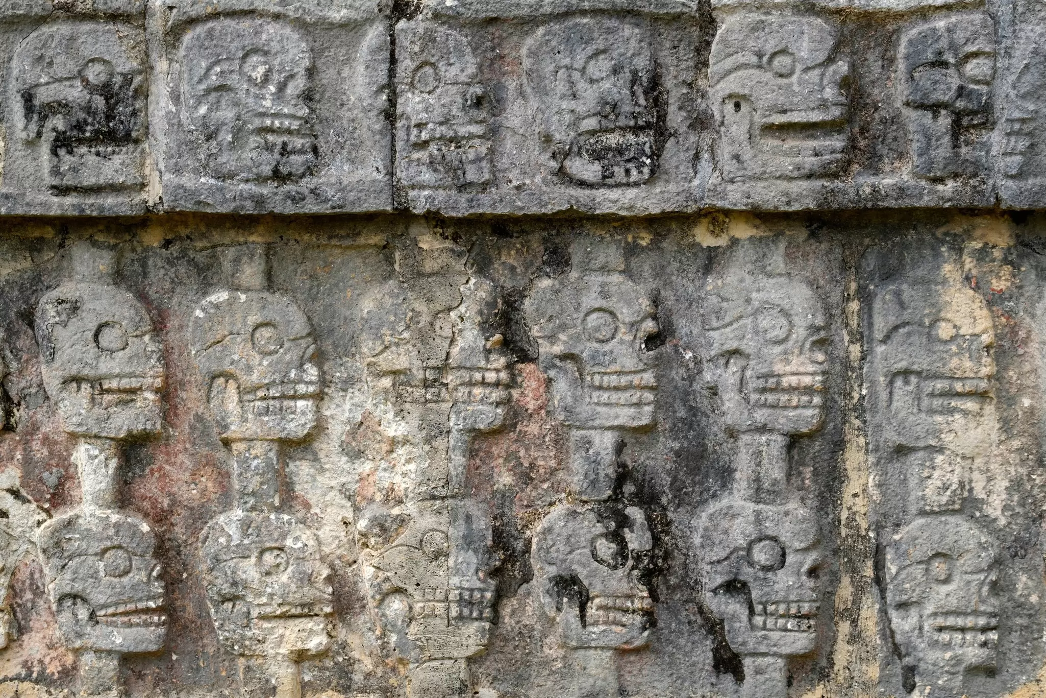 Close-up of the carvings of skulls on the Plataforma de los Cráneos (Platform of Skulls; Tzompantli in Náhuatl) at Chichén Itzá, Mexico.