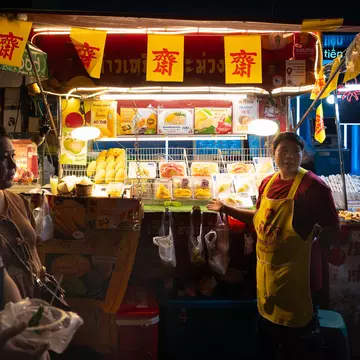 A street food vendor in Bangkok's Chinatown at night.