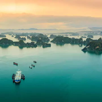 Many islets stretch into the distance of the ocean reflecting the sunlight, viewed from a seaplane