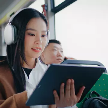Young Chinese girl with long black hair using tablet with big screen. Navigating in device with one hand. Enjoying music in white headphones. Entertaining herself with digital devices., License Type: media, Download Time: 2025-03-10T19:53:47.000Z, User: dermothegarty77, Editorial: false, purchase_order: 56530 - Guidebooks, job: Global Publishing WIP, client: China 17 , other: Dermot Hegarty