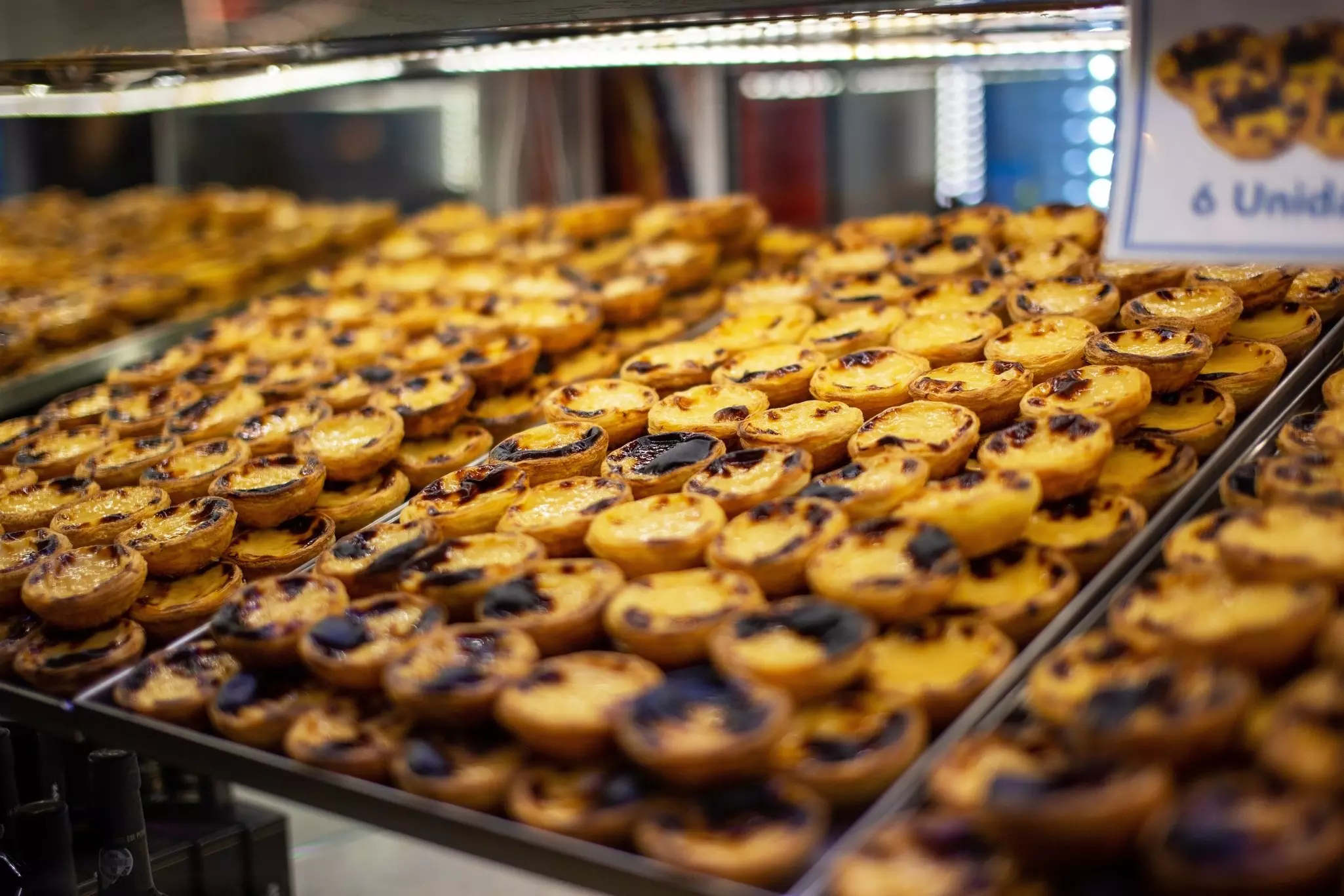 Trays packed with custard tarts in a bakery