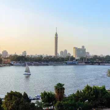 The Nile River weaving through the city of Cairo, with a few small sail boats