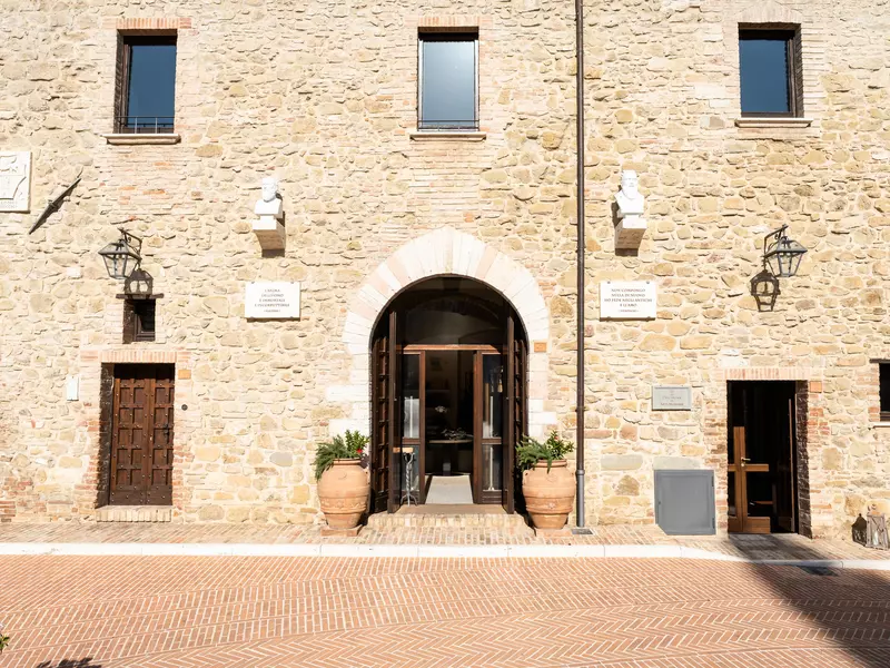 Exterior of Brunello Cucinelli's shop, a beautiful stone building