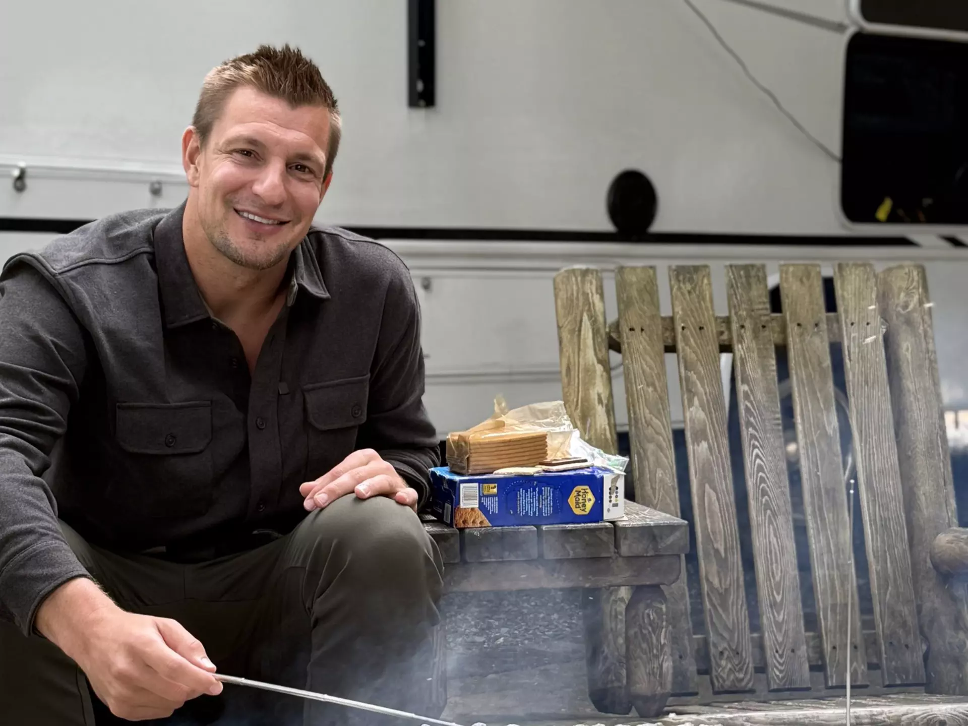 Famed former NFL player Rob Gronkowski, more commonly known as "Gronk," makes s'mores outside his RV. Go RVing
