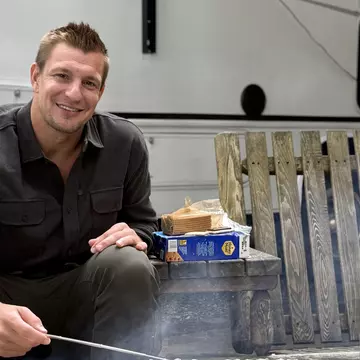 Famed former NFL player Rob Gronkowski, more commonly known as "Gronk," makes s'mores outside his RV. Go RVing