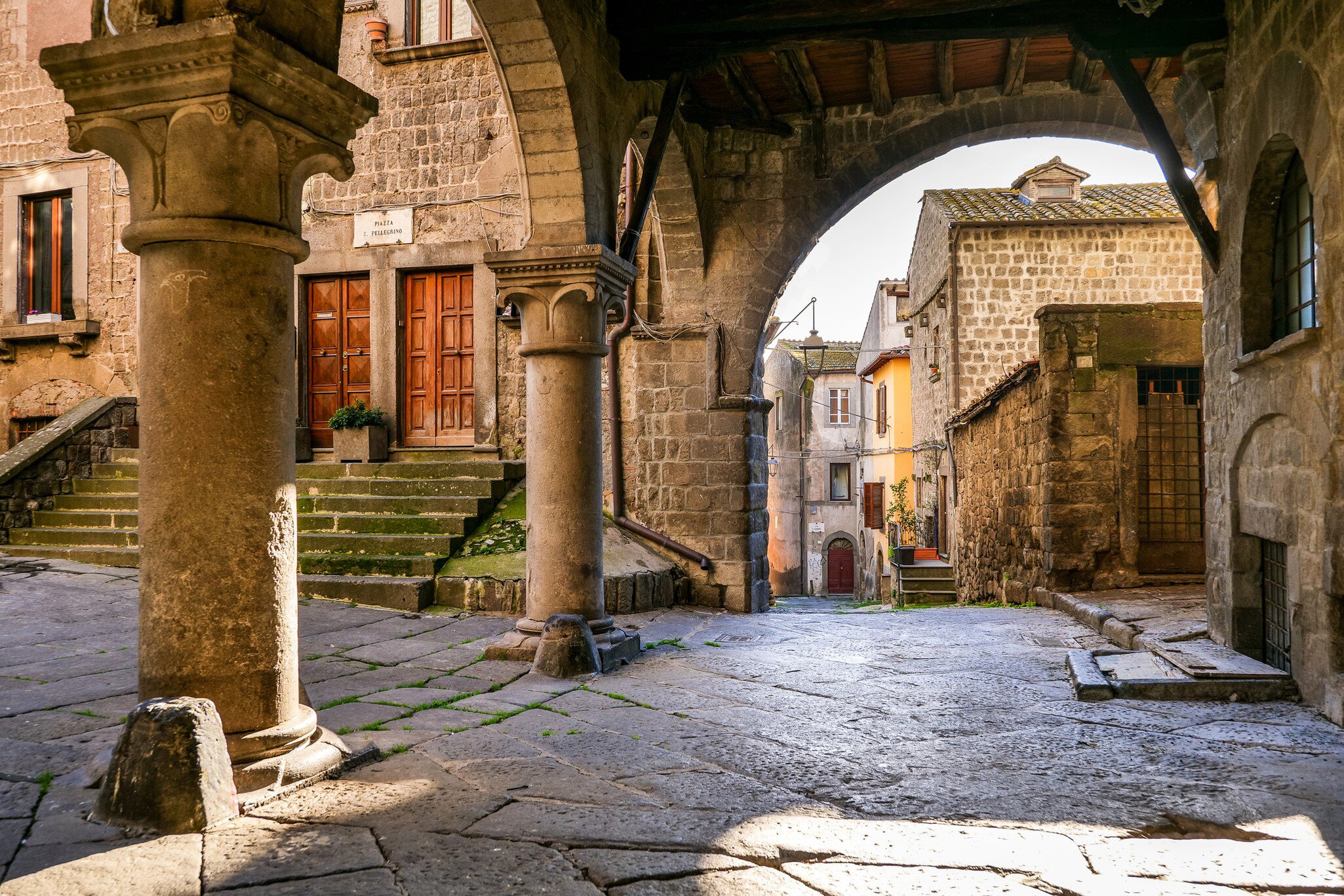 The beautiful stone portico in the square of San Pellegrino in the medieval heart of Viterbo in central Italy.
