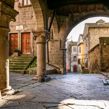 The beautiful stone portico in the square of San Pellegrino in the medieval heart of Viterbo in central Italy.