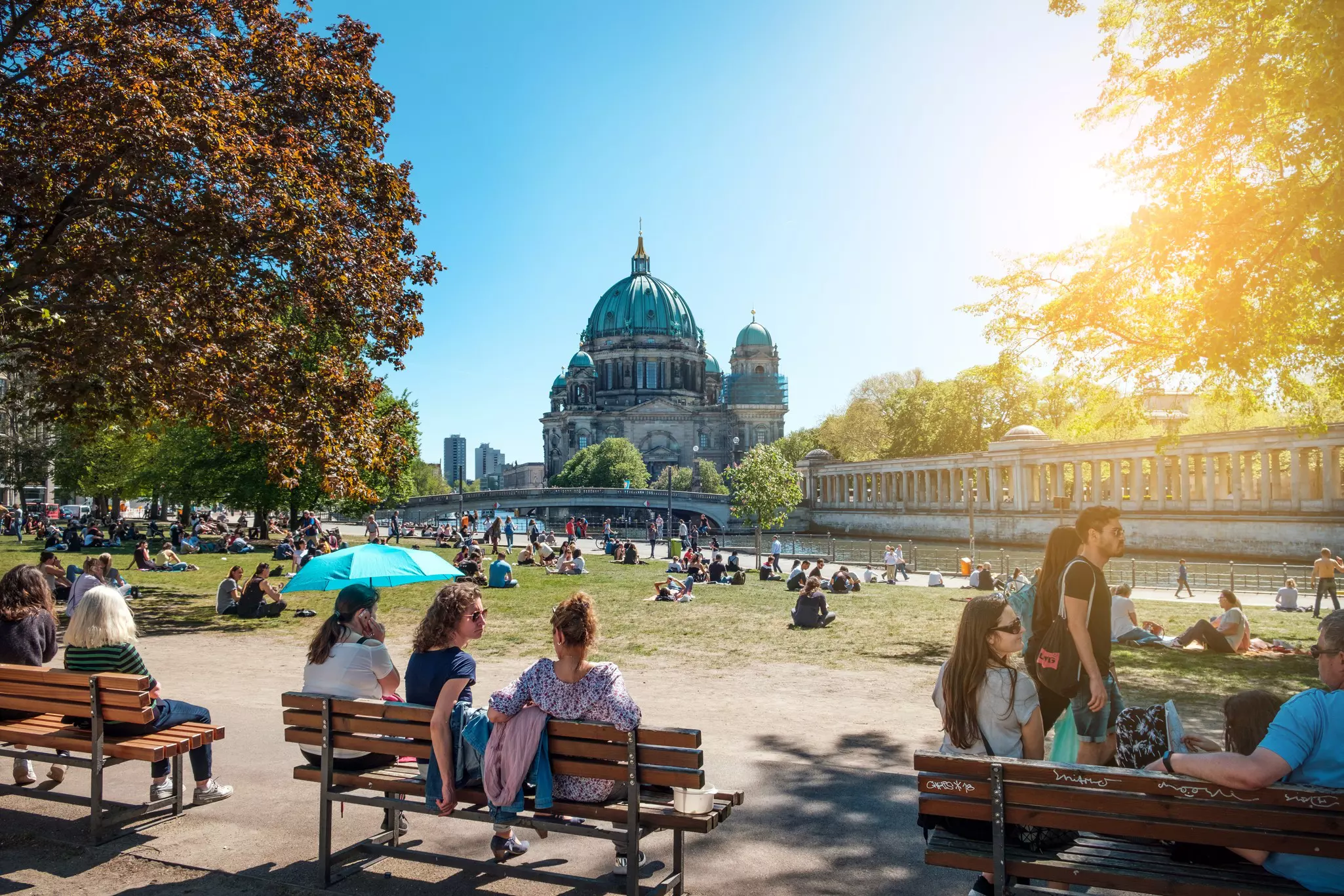 Berlin, Germany - April, 2019: People in public park on a sunny day near Museum Island and Berlin Cathedral.