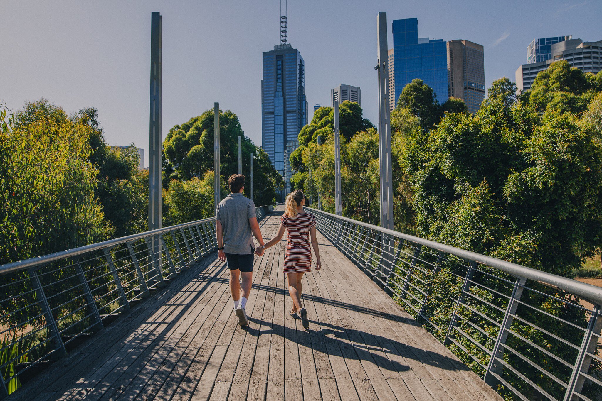 Young couple walking through Birrarung Marr in Melbourne, Australia.