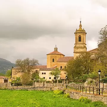View of the tower and monastery complex of Abadía de Santo Domingo de Silos in Spain.