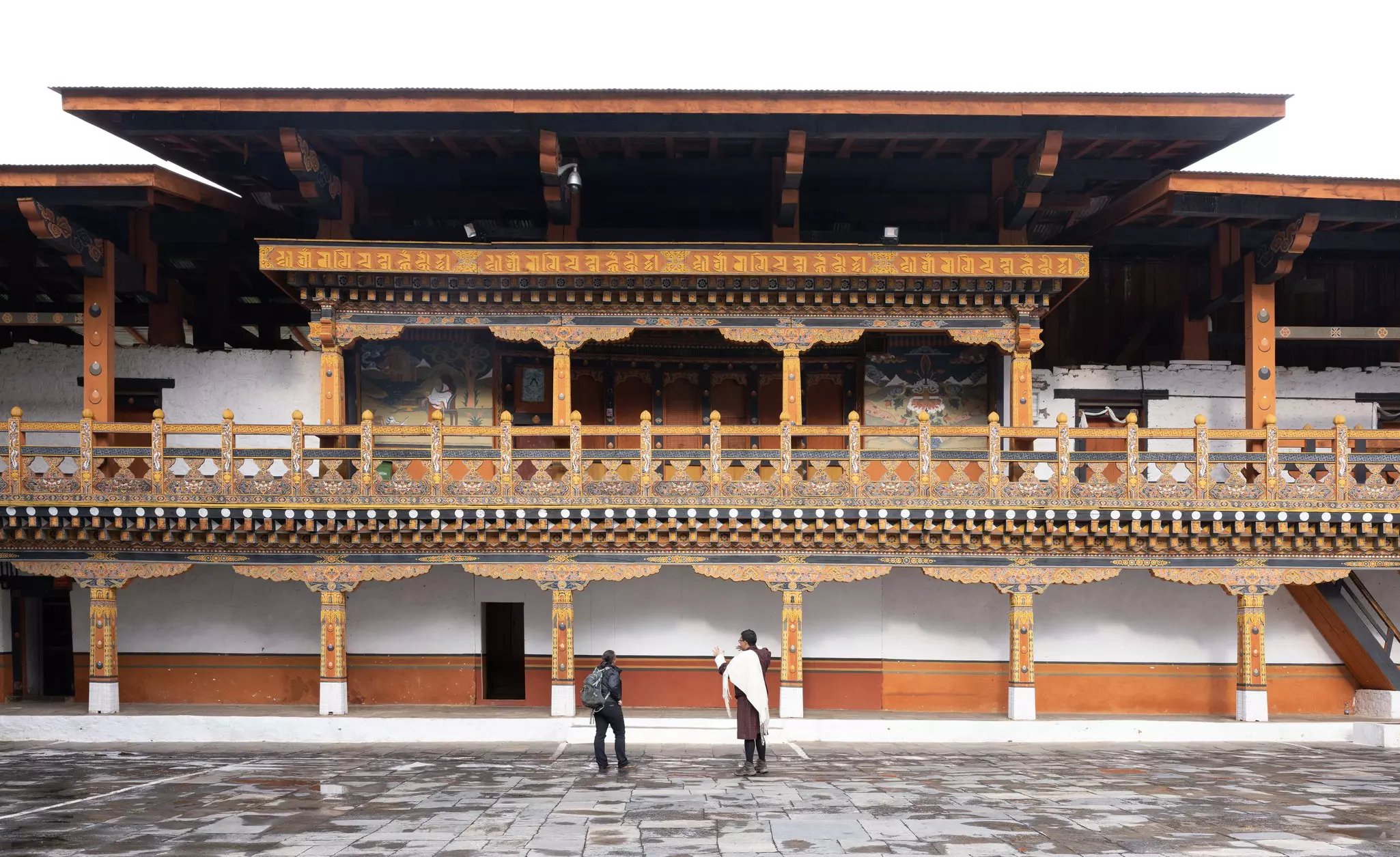 A guide explains the intricate artwork of Punakha Dzong.  © Ken Spence
