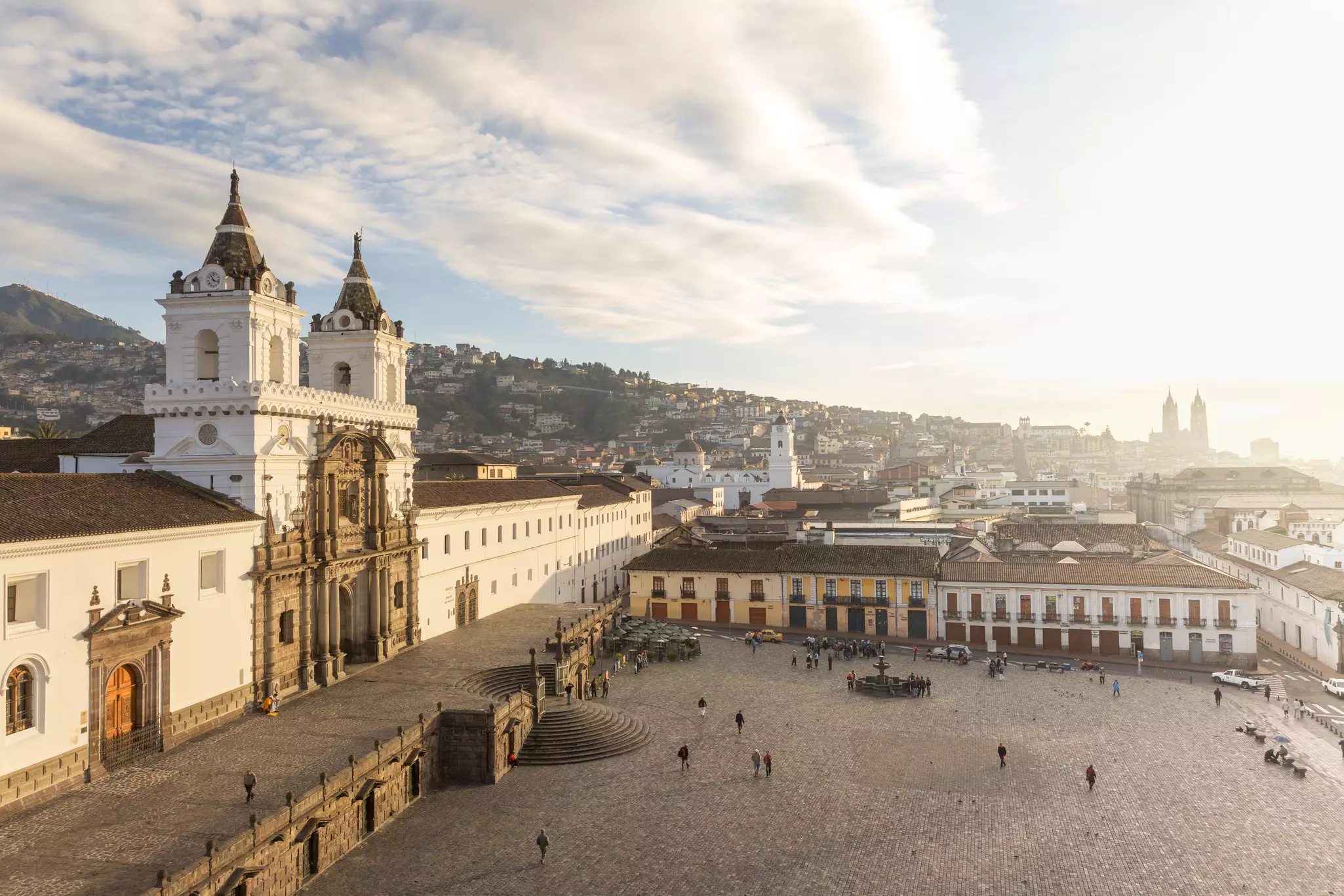 A large city square dominated on the left by a vast colonial church building