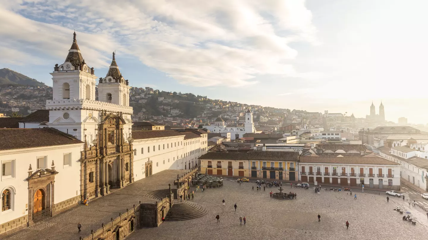 A large city square dominated on the left by a vast colonial church building