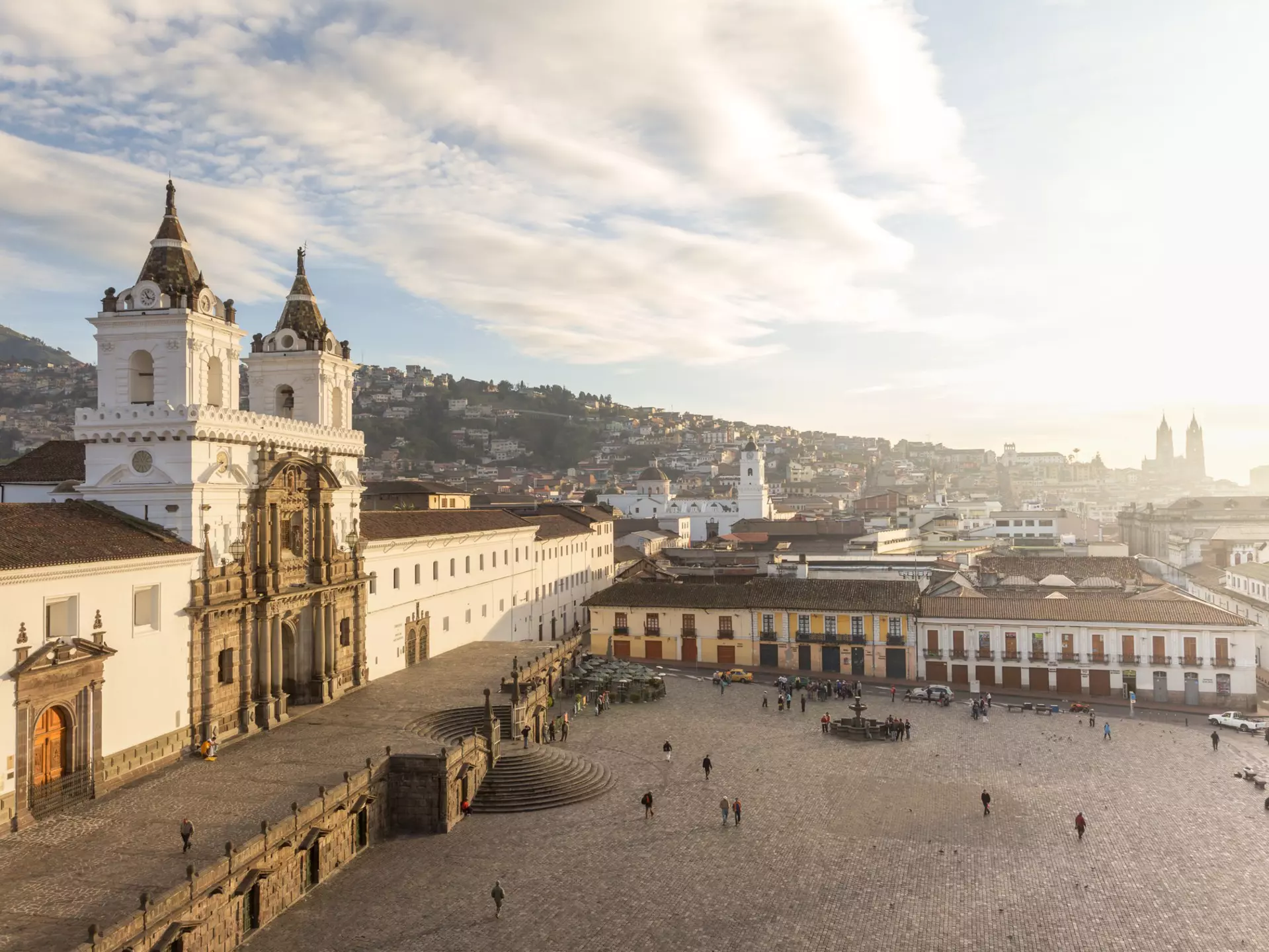 A large city square dominated on the left by a vast colonial church building