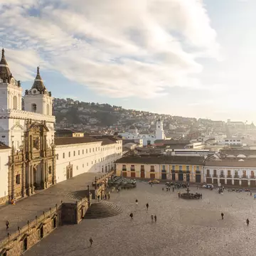 A large city square dominated on the left by a vast colonial church building