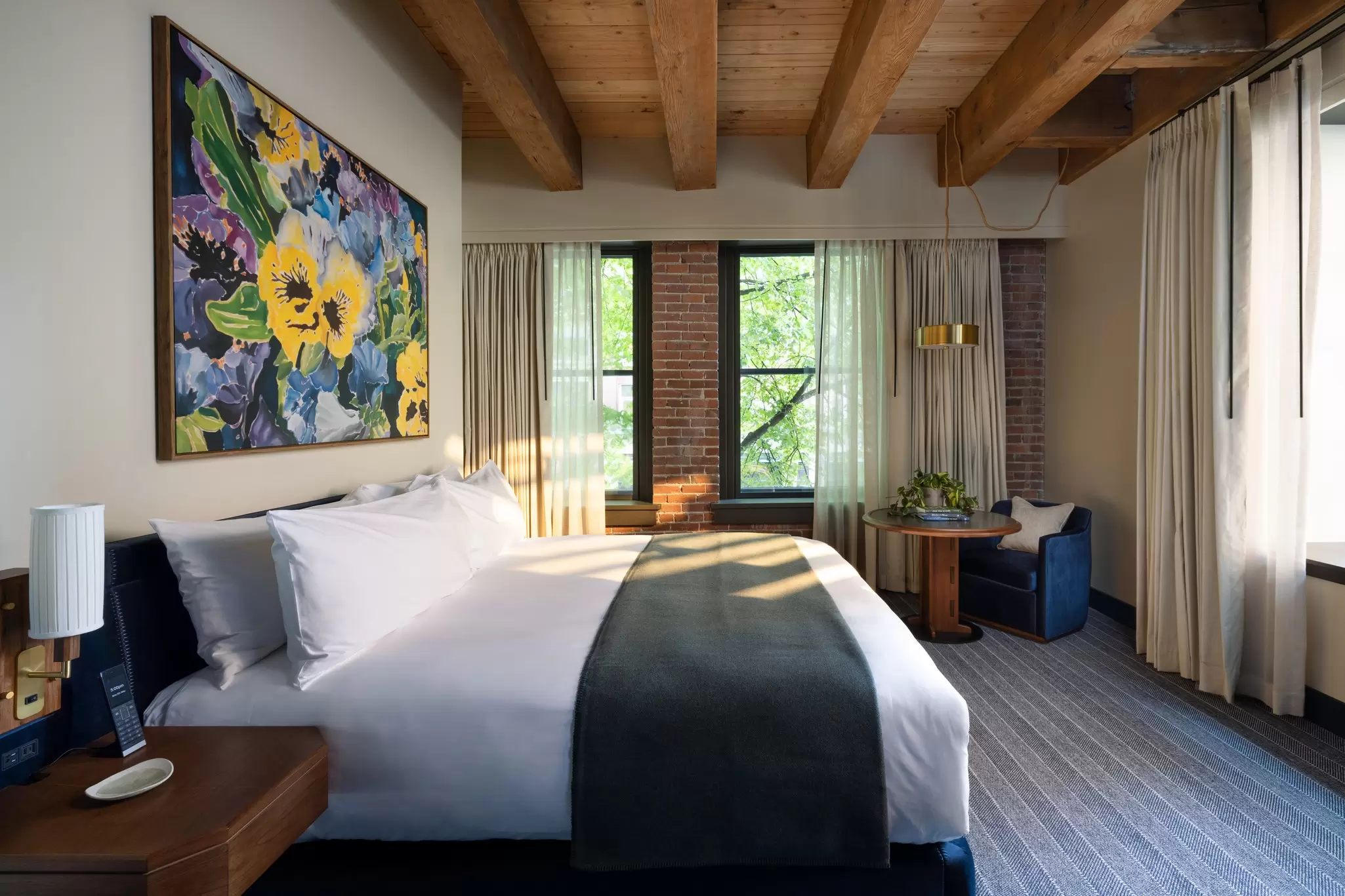 King size bed in a hotel room at the Populus Hotel.