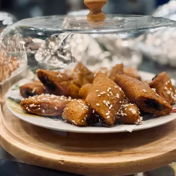 Tunisian makroudh pastries for sale in a cafe.
