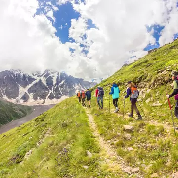 JULY 29, 2018: A group of climbers follow each other in a chain while climbing Mt Elbrus.