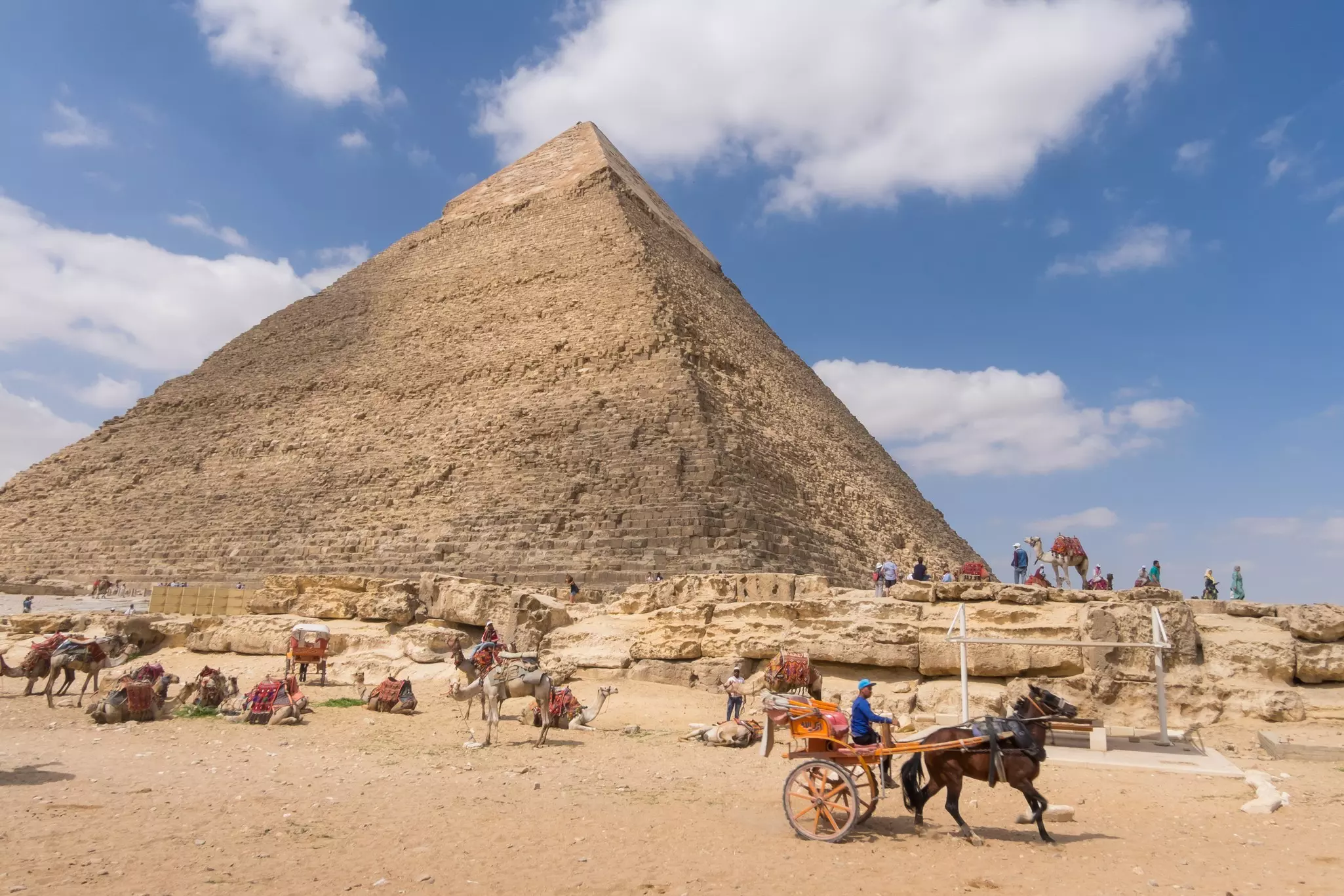 Camels and horse-drawn carriages next to the Pyramid of Khafre in Giza.