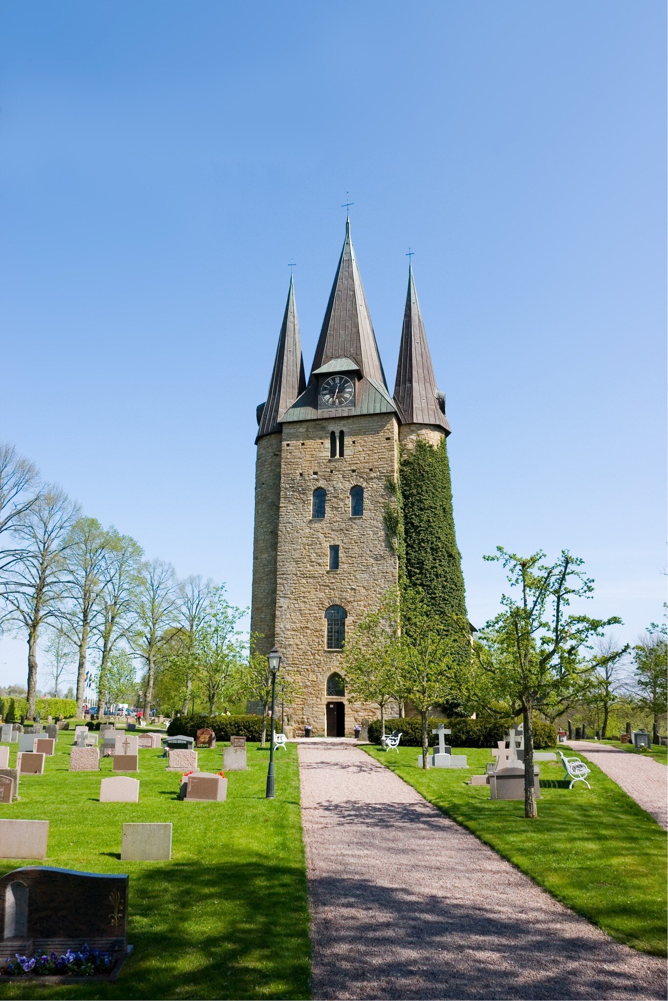 View of a church and graveyard in Husaby on a sunny day in Sweden.