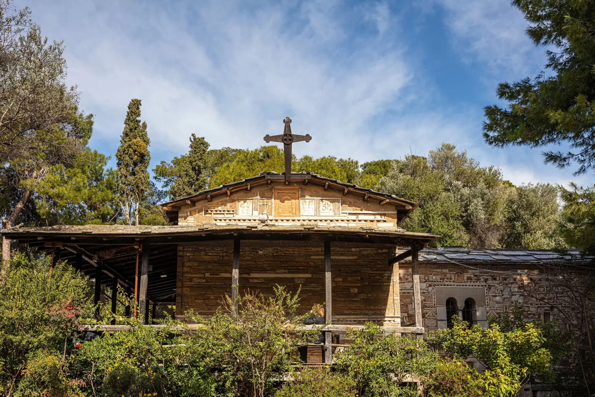 A large wooden-framed church in woodland: Church of Agios Dimitrios Loumbardiaris, Athens.
