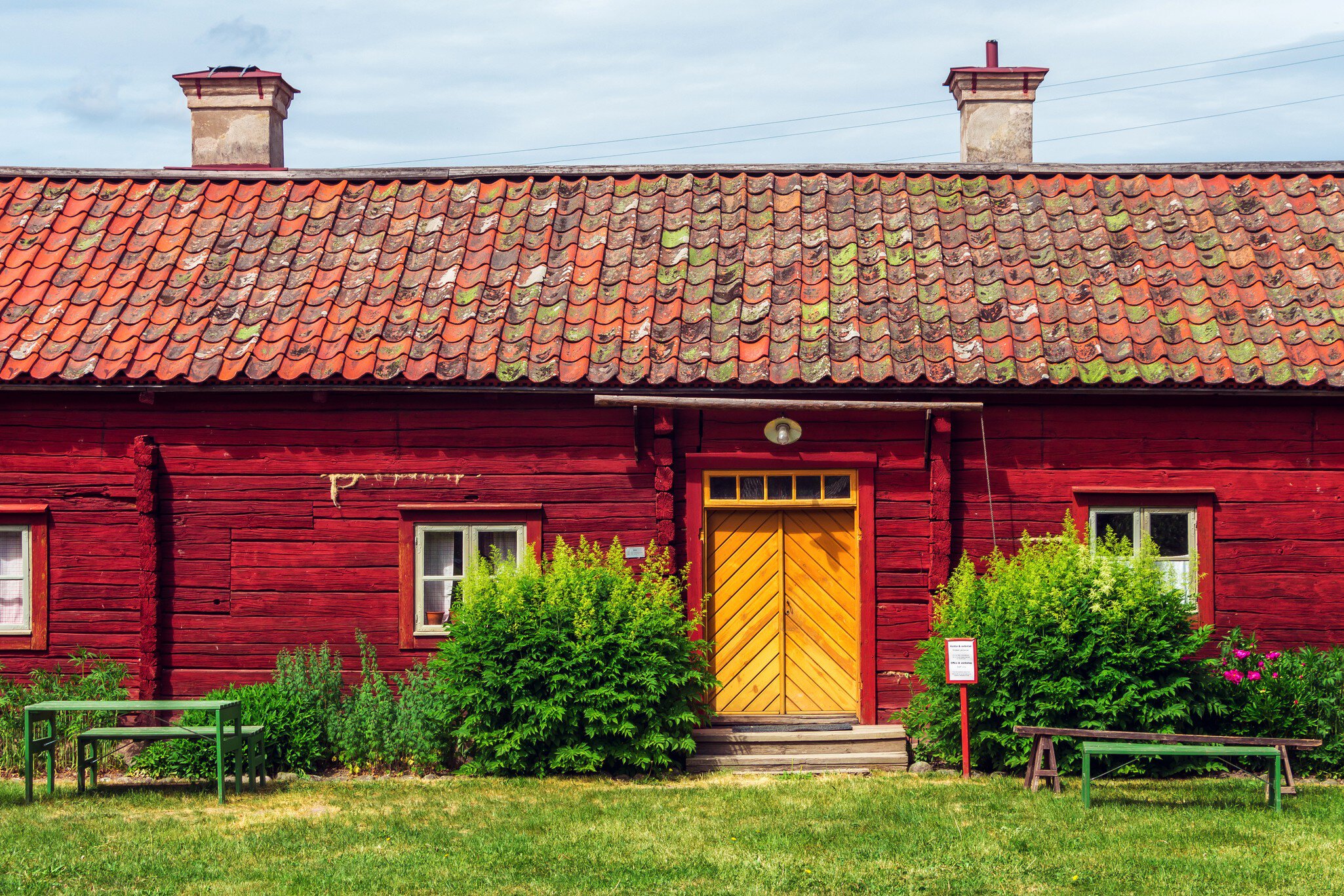 Uppsala, Sweden, June 6, 2018: Red wooden building in Disagarden (Disagården - open air museum of Old Uppsala (70 km from Stockholm). Uppland village in mid-1800s. Front view.  Sunny day., License Type: media, Download Time: 2026-06-09T19:37:52.000Z, User: LP_NZhan, Editorial: true, purchase_order: 65050 - Digital Destinations and Articles, job: App Content, client: Lonely Planet App, other: Nadine Zhan