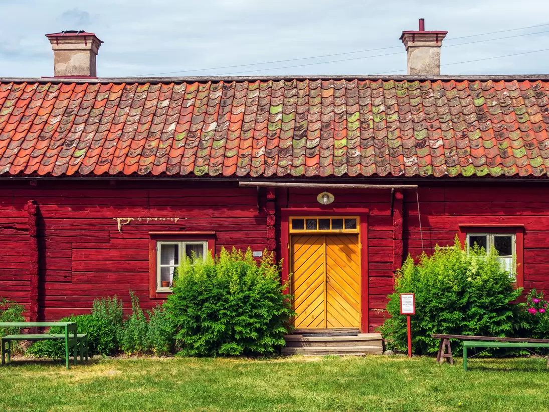 Uppsala, Sweden, June 6, 2018: Red wooden building in Disagarden (Disagården - open air museum of Old Uppsala (70 km from Stockholm). Uppland village in mid-1800s. Front view.  Sunny day., License Type: media, Download Time: 2026-06-09T19:37:52.000Z, User: LP_NZhan, Editorial: true, purchase_order: 65050 - Digital Destinations and Articles, job: App Content, client: Lonely Planet App, other: Nadine Zhan