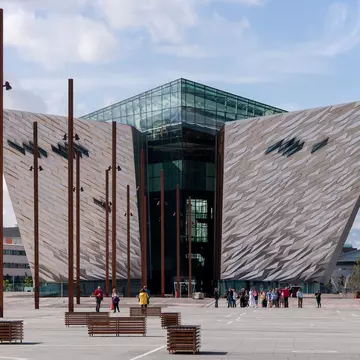 A museum in Belfast's Titanic Quarter has two angled wings and glass-enclosed center.