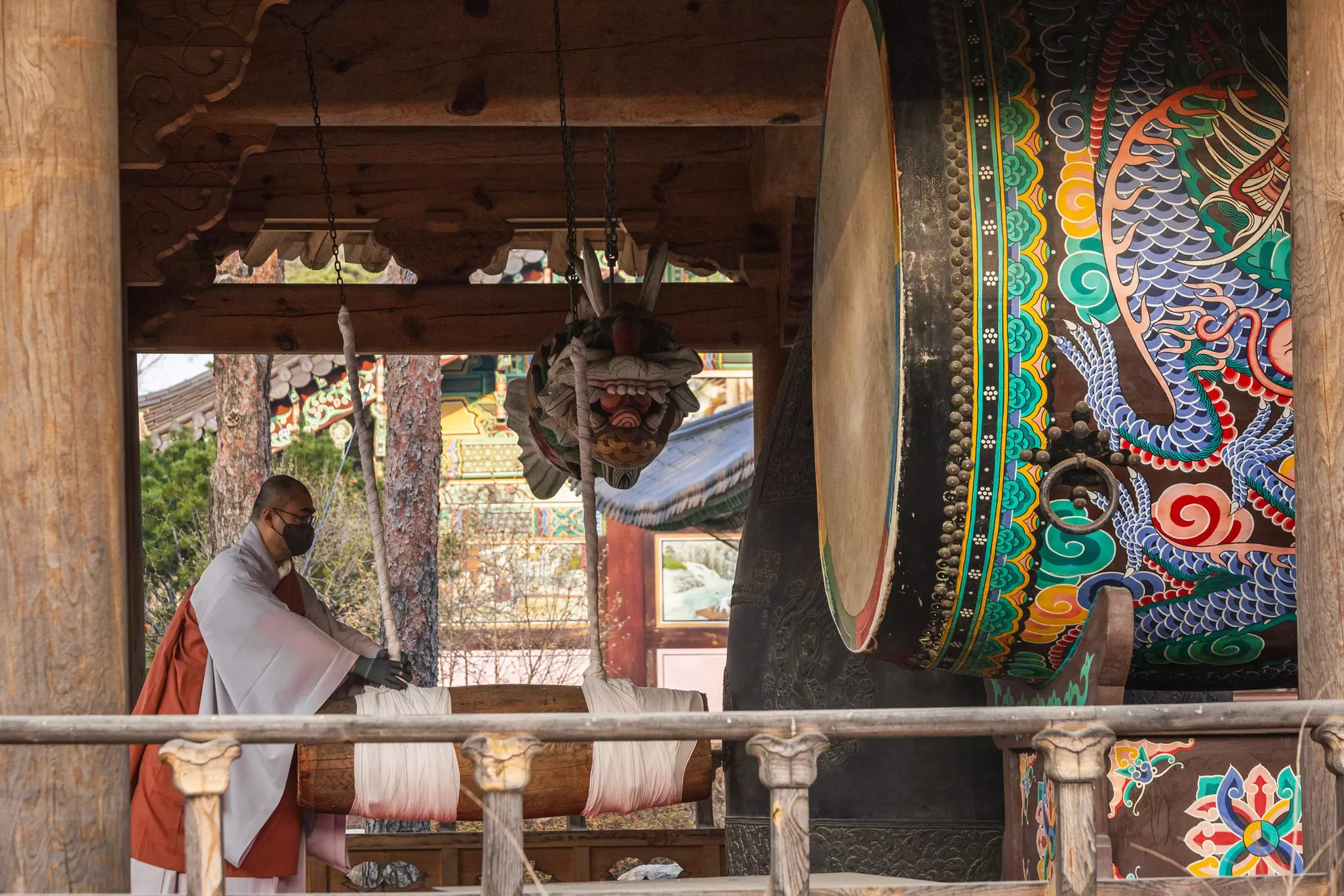 A Buddhist monk plays a big drum in Bongeunsa Temple in Korea, located in the building forest of Gangnam, Seoul © RuslanKaln/Getty Images