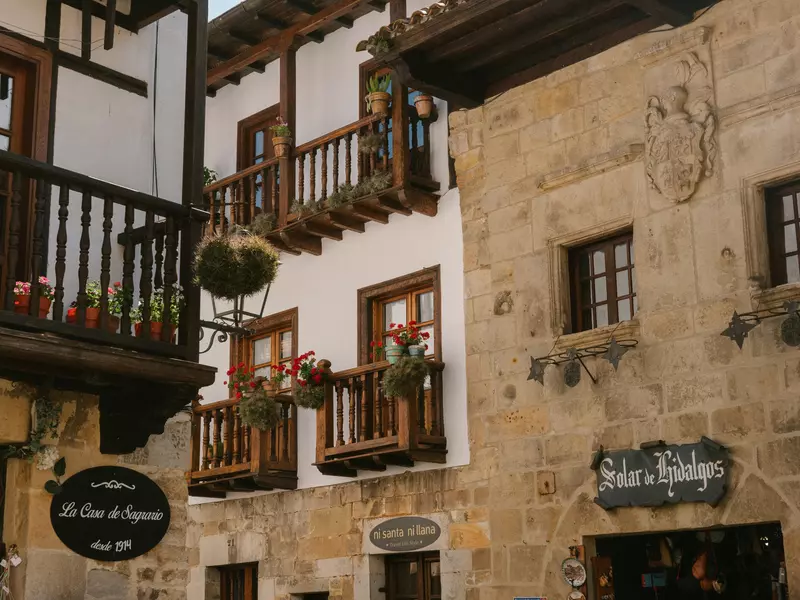 A medieval town with whitewashed buildings with wooden balconies.