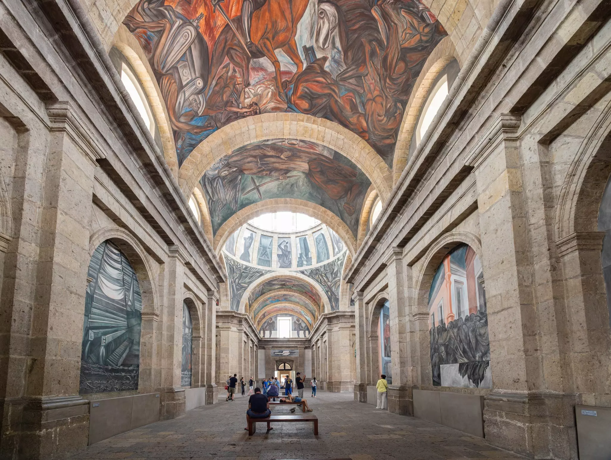 A large hall with murals displayed on the walls and ceilings.