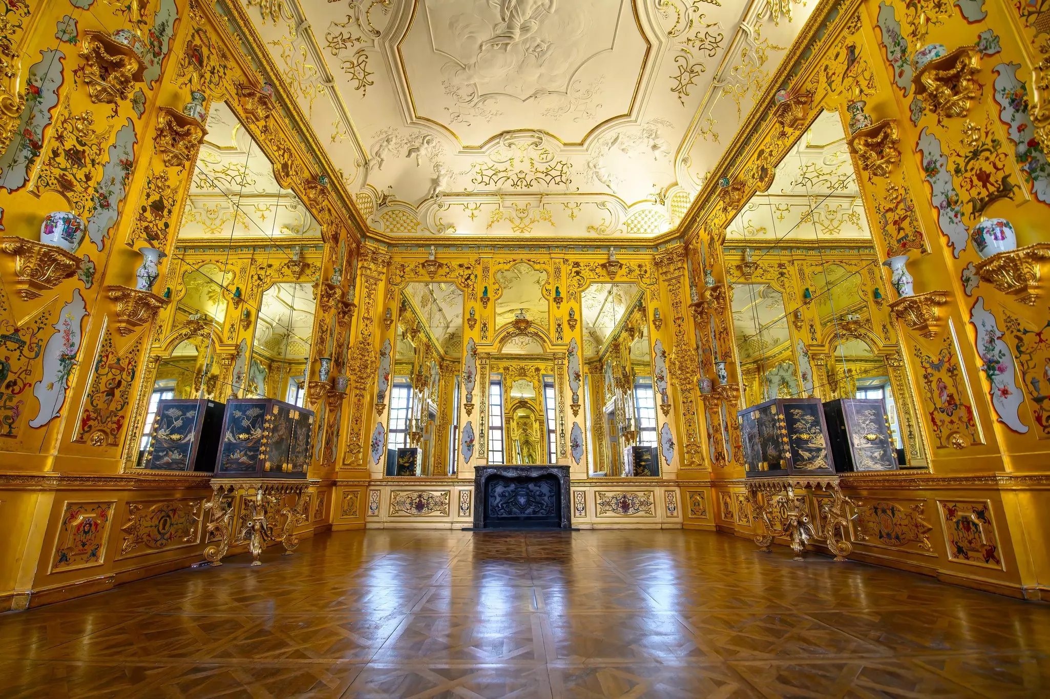 An ornate gold-accented room in a museum in Vienna.