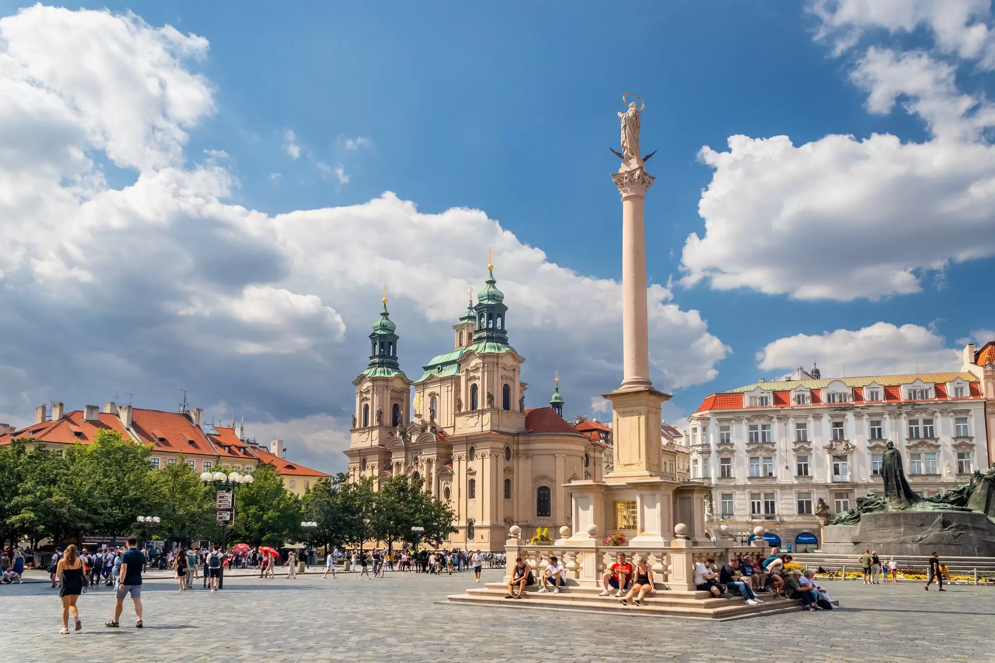 View of the Church of St. Nicholas from across the Old Town Square on a sunny day in Prague, Czechia.