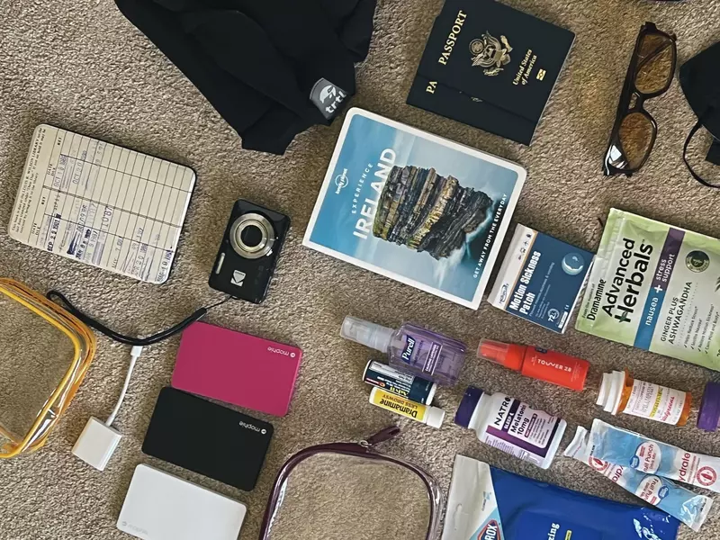 Must-have items for a plane ride, including passport, medication, chargers, etc.