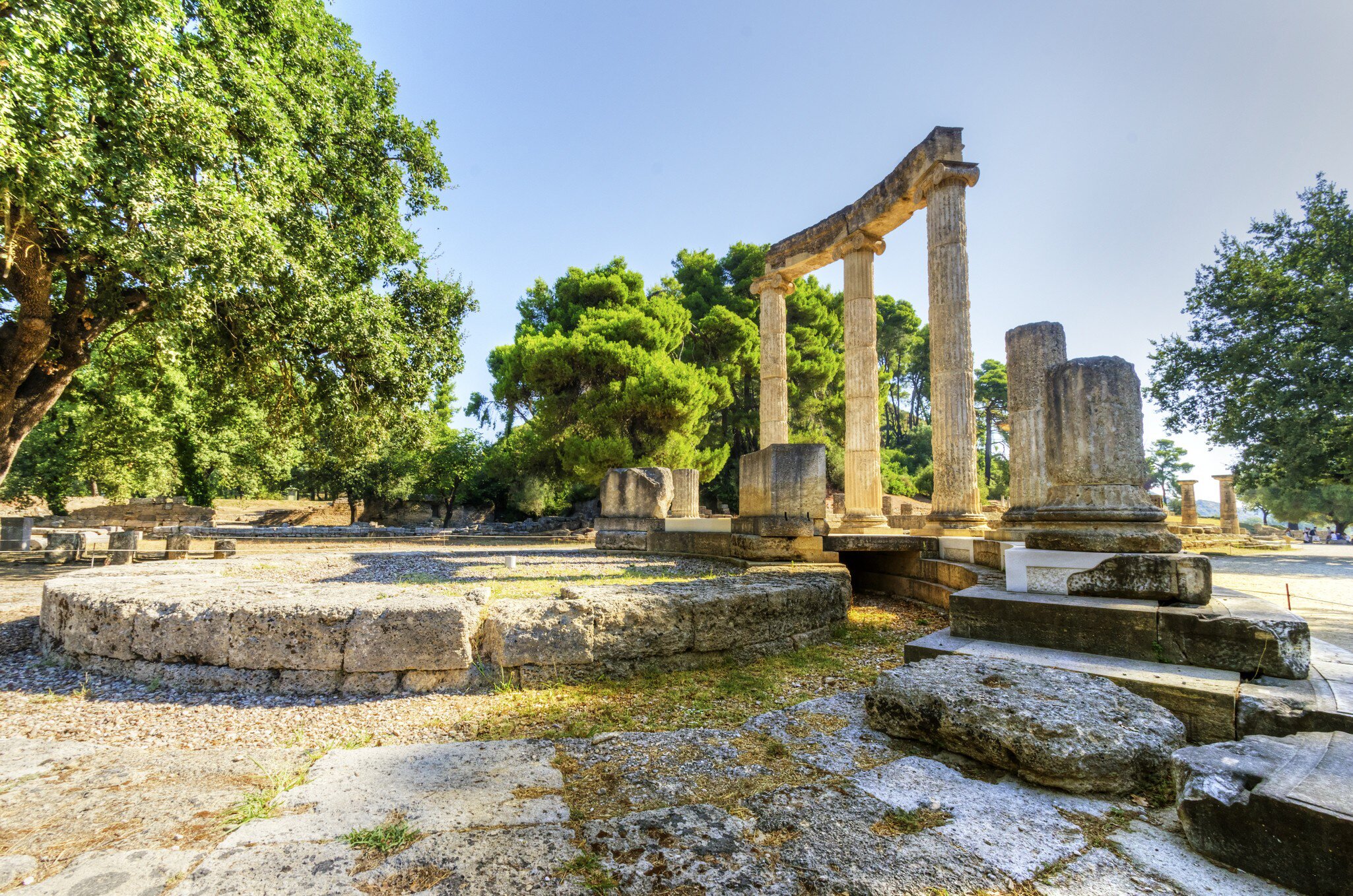 Ruins at an ancient site with tall columns in a semicircle