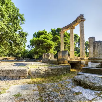 Ruins at an ancient site with tall columns in a semicircle