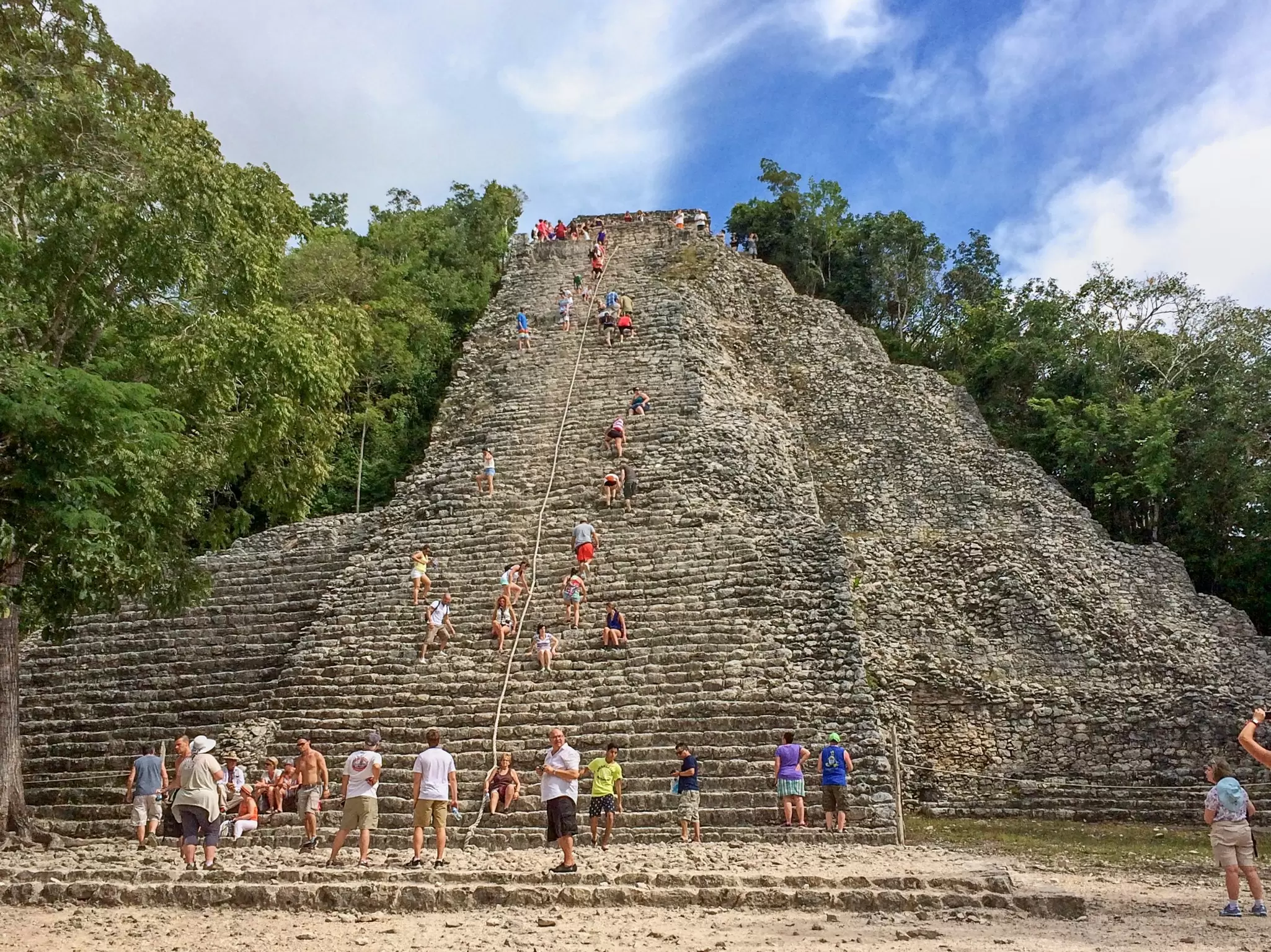 People climb the steps of an ancient pyramid at the Maya site of Cobá, Yucatán Peninsula, Quintana Roo, Mexico