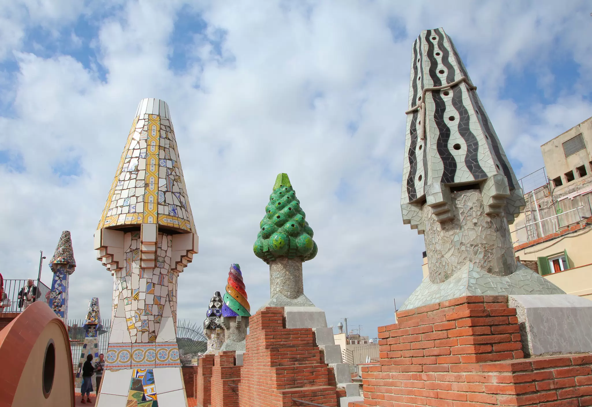 View of colorful mosaic chimneys on the roof of Palau Güell in Barcelona, Spain.