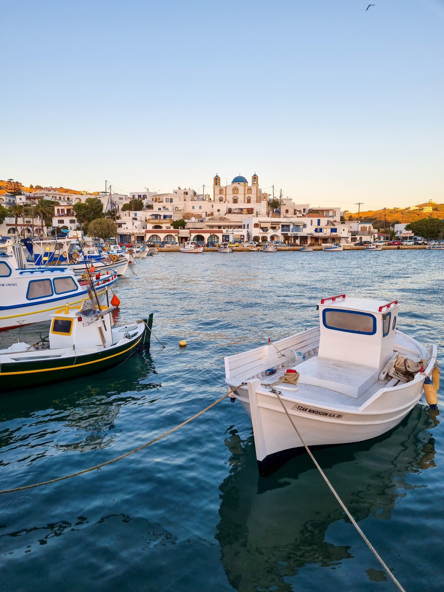 Harbour view to Lipsi with a Greek orthodox church with a blue dome in the background, hidden gem in the Aegean sea, Dodecanese, Greece.