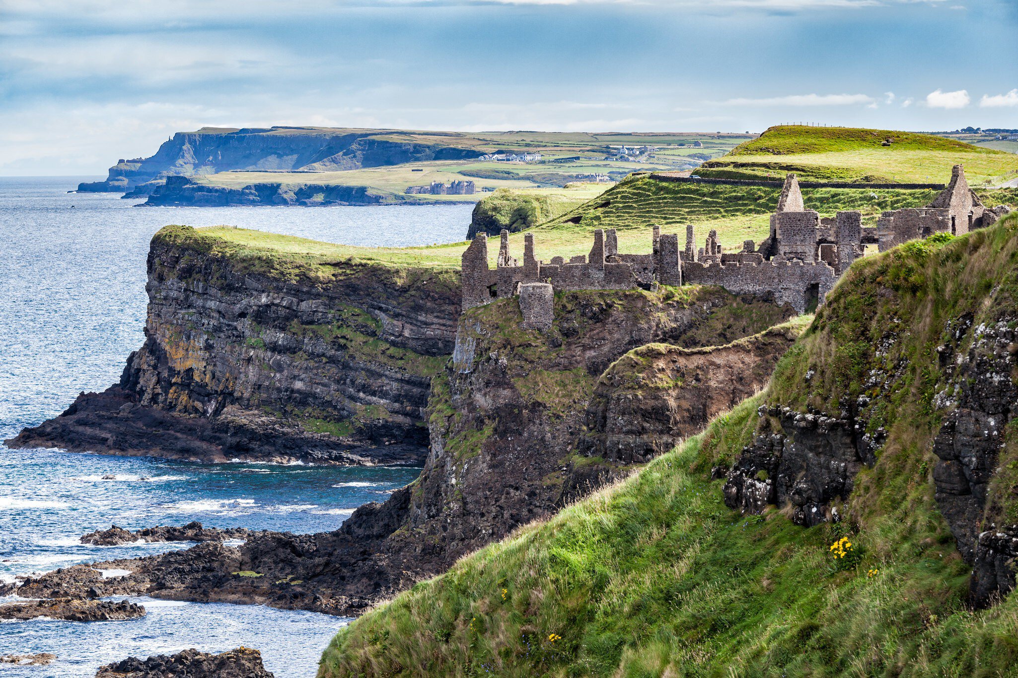The ruins of Dunluce Castle atop the sea cliffs at Magheracross, Northern Ireland
