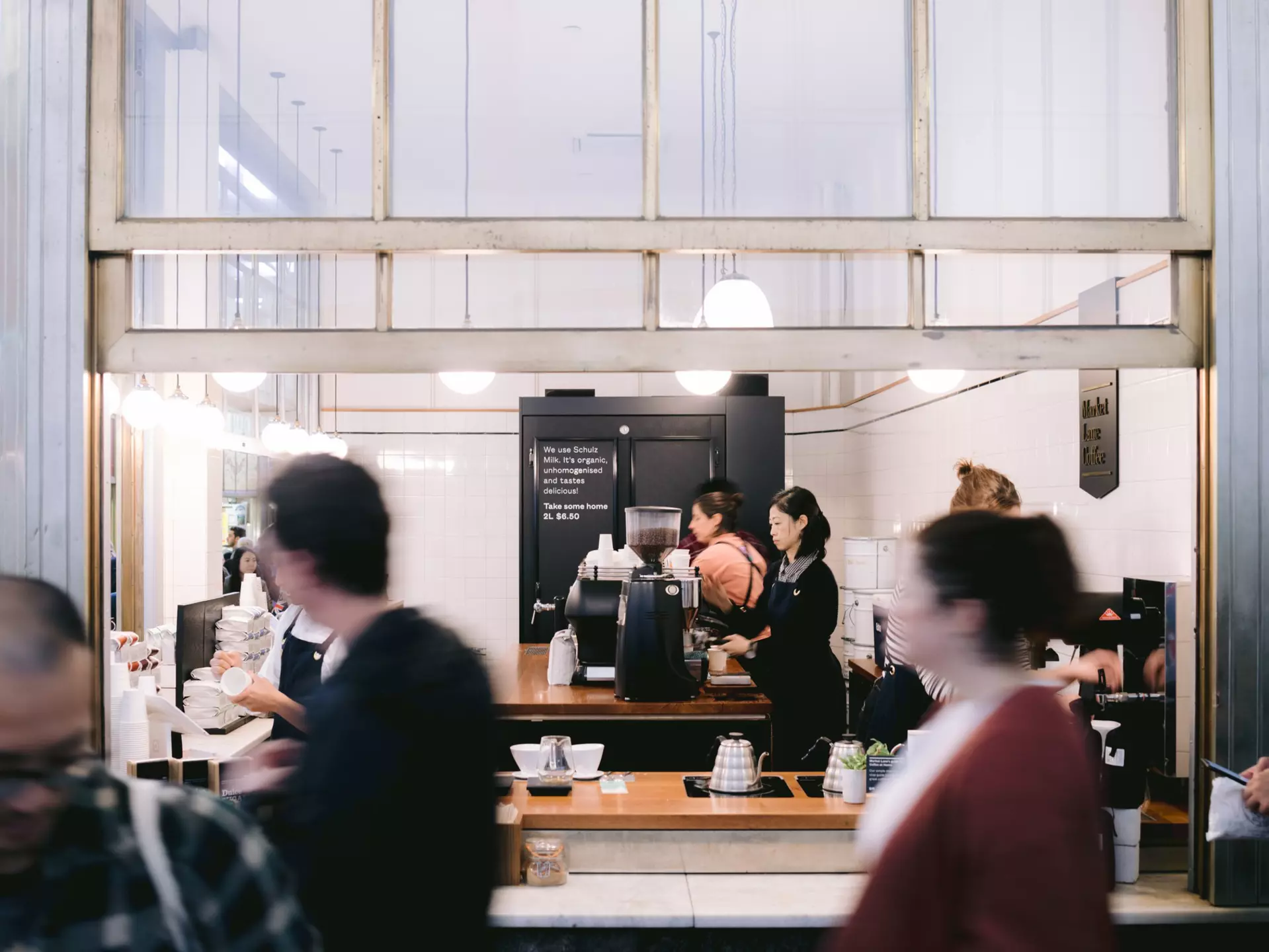 Barista and customers on a busy day at Market Lane Coffee in Melbourne, Australia.