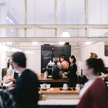 Barista and customers on a busy day at Market Lane Coffee in Melbourne, Australia.
