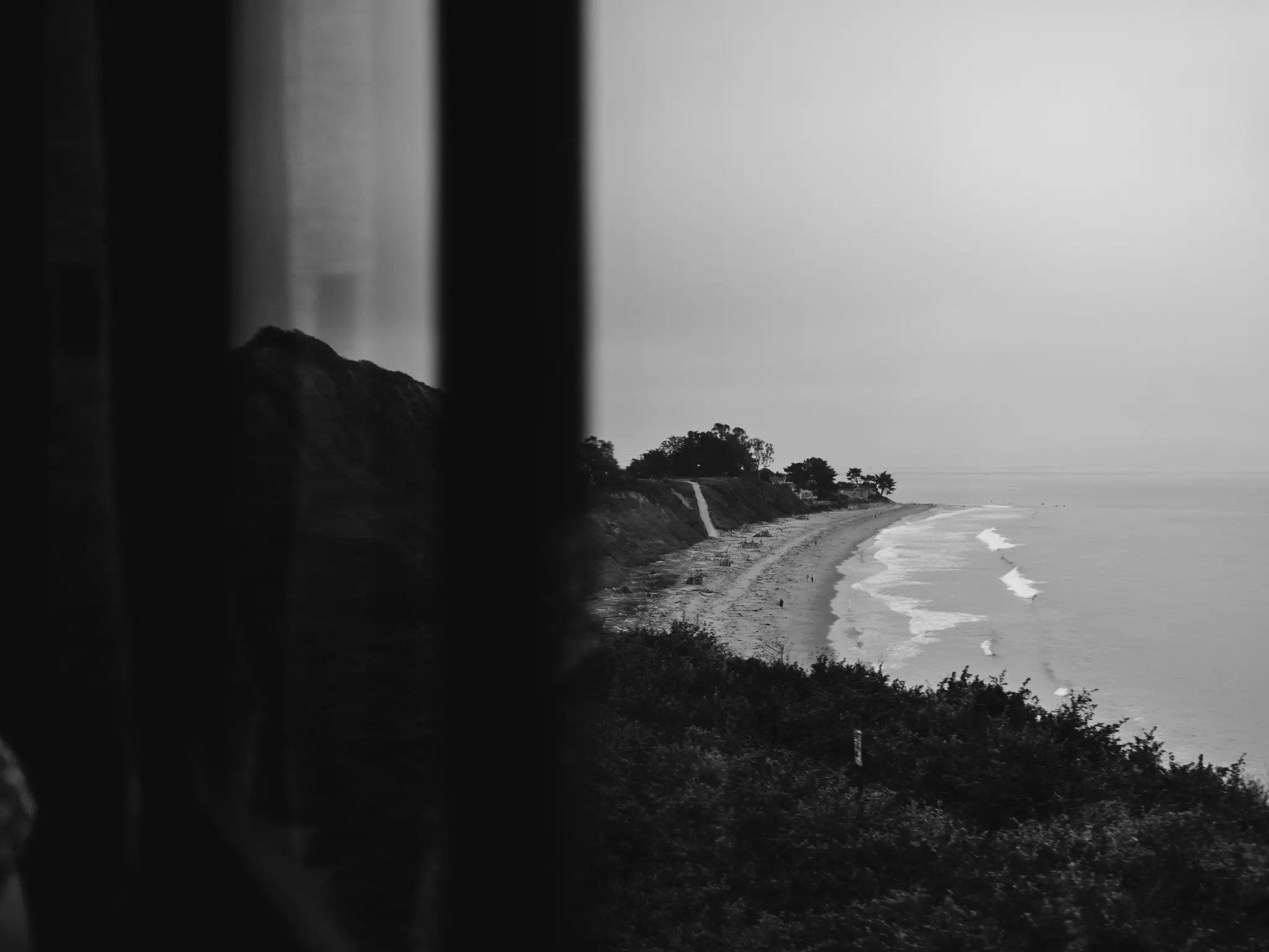 A view of a beach through a window.