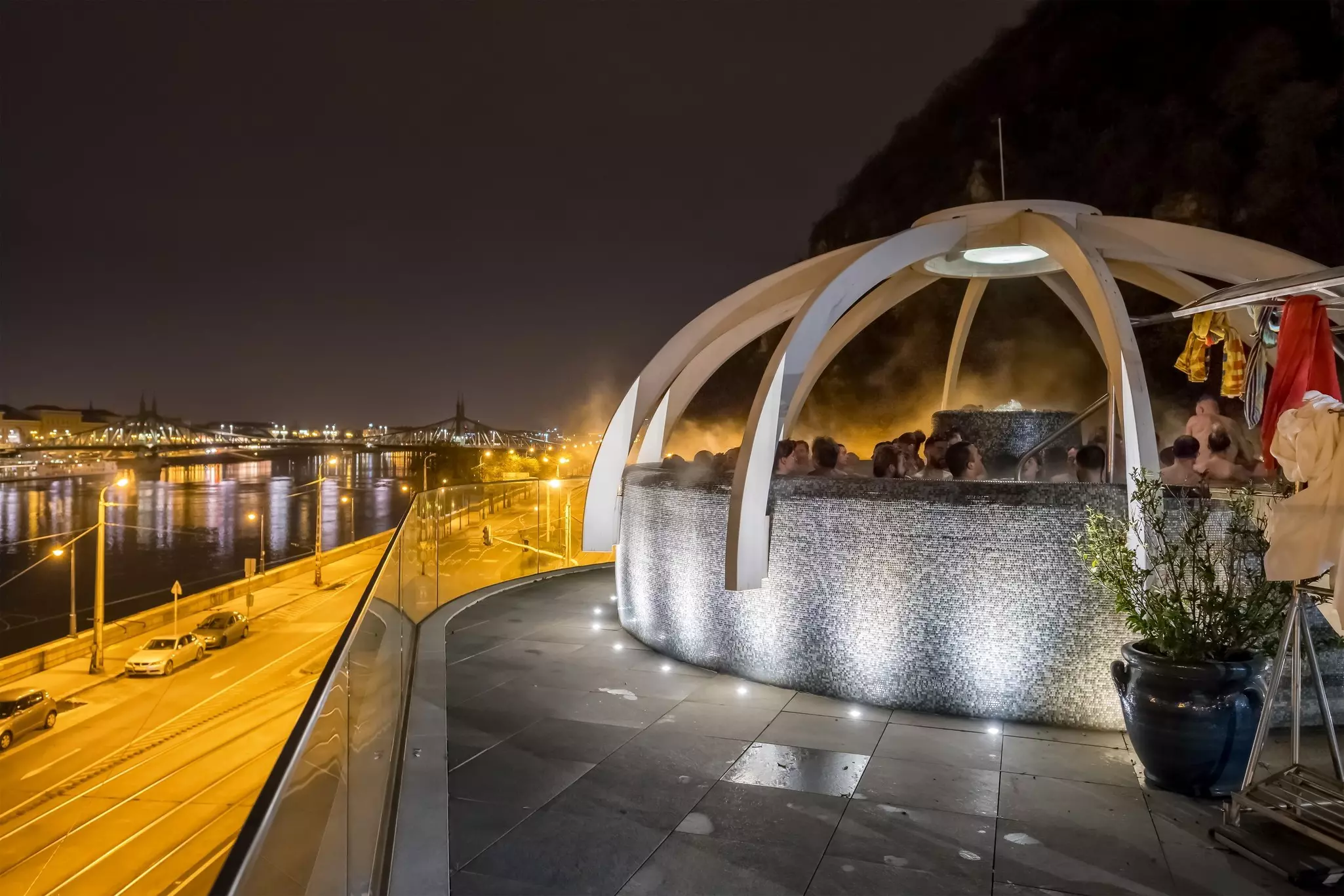 Budapest, Hungary - November 20, 2022: Unidentified people enjoying rooftop thermal pool at night in Budapest. Rudas Thermal Bath and Spa over Danube River, License Type: media, Download Time: 2025-07-24T11:25:05.000Z, User: clairenaylor, Editorial: true, purchase_order: 65050 - Digital Destinations and Articles, job: Online editorial, client: Budapest thermal baths , other: Claire Naylor