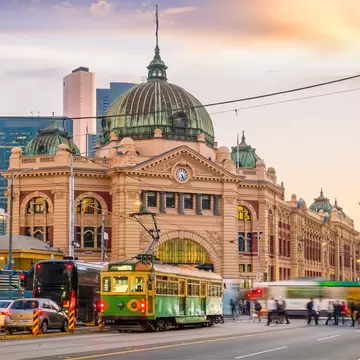 View of Melbourne's Flinders Street Train Station in Australia at sunset.